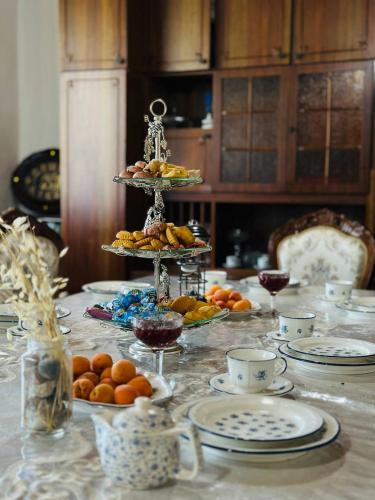 a table with plates and bowls of food on it at Uruyat Nomad guesthouse in Naryn