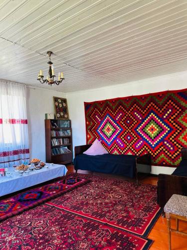 a living room with a bed and a rug at Uruyat Nomad guesthouse in Naryn