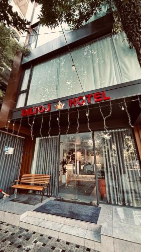 a store with a bench in front of a building at Diltoj Hotel Tashkent in Tashkent