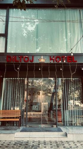a store front with a bench in front of a window at Diltoj Hotel Tashkent in Tashkent