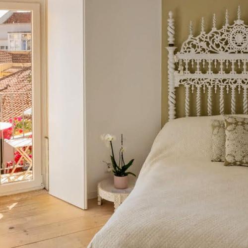 a bedroom with a bed and a door with a window at Tings Lisbon in Lisbon