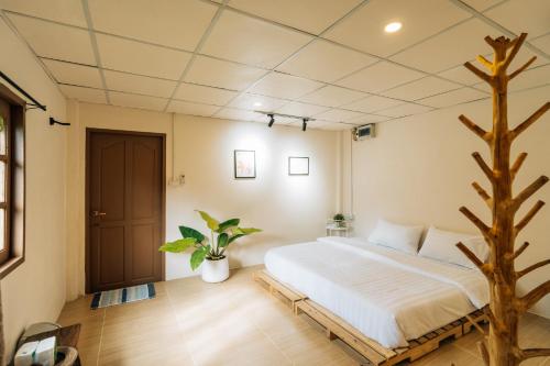 a bedroom with a bed and a tree in it at Always Boutique Stay in Pai