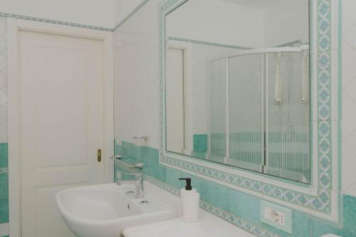 a bathroom with a sink and a mirror at gardeniapartment in Minori