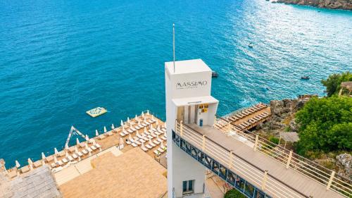 a lighthouse with chairs and the ocean in the background at Massimo Hotel - Adults Only 'Ex La Boutique Hotels' in Antalya