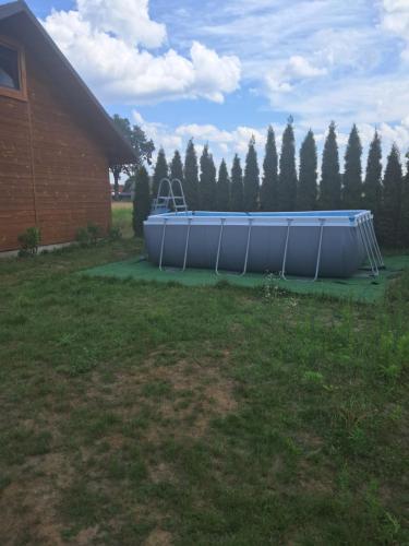a boat sitting in a yard next to a house at Gucio in Zwierzyniec