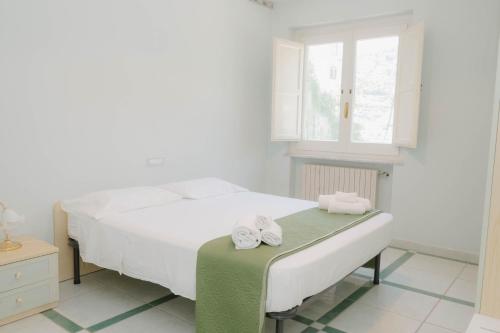 a bedroom with a bed and a table with shoes on it at gardeniapartment in Minori