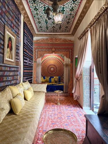 a room with a bed with a painting on the ceiling at Sherezade Riad in Tétouan