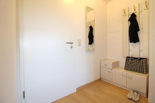 a room with a closet with a dresser and a mirror at Haus Koppelweg FW-Fisch in Ahrenshoop