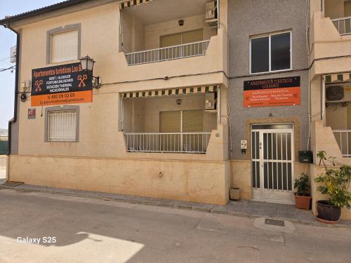a building with signs on the side of it at Apartamentos turisticos los baños in Fortuna