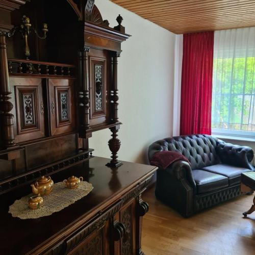 a living room with a couch and a chair at Haus Nummer 7 in Manderscheid