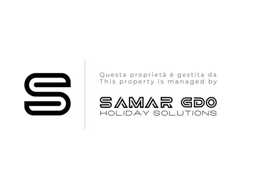 a logo for samsara gdm holiday solutions at Apartment Portico I in Castelveccana