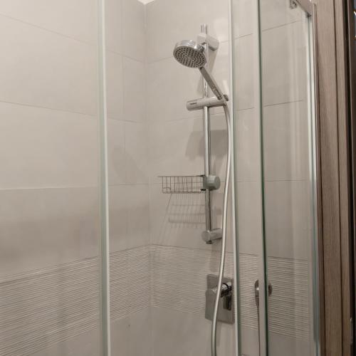 a shower with a glass door in a bathroom at Brezza marina in Alghero