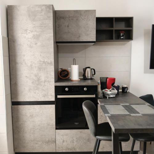 a kitchen with a black stove and a table at Brezza marina in Alghero