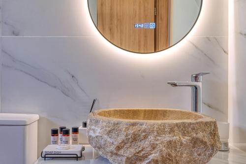 a bathroom with a large rock sink in a bathroom at Thymele Stone House in Lygourio