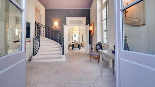 a hallway of a home with a staircase and a stair case at Château de Candes - Art & Spa in Candes-Saint-Martin