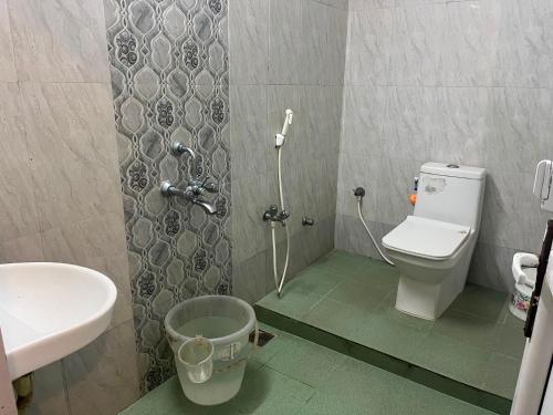 a small bathroom with a toilet and a sink at Serenity Sunrise Beach Resort in Pondicherry