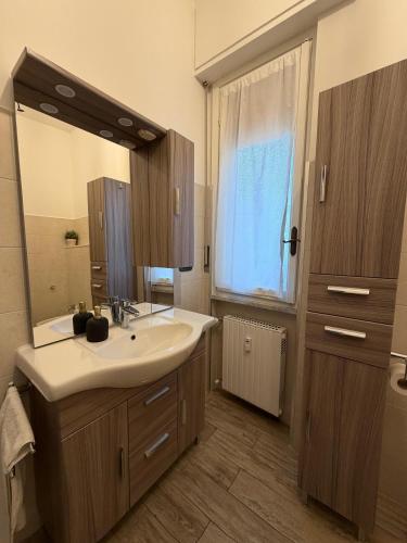 a bathroom with a sink and a large mirror at Zuly House in Savona