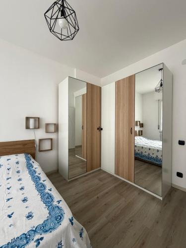 a bedroom with a bed and a large mirror at Zuly House in Savona