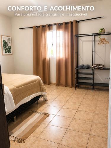a bedroom with a bed and a tiled floor at Casa do Lago in Londrina