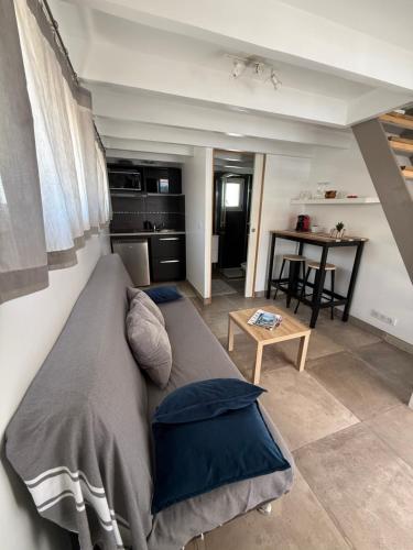 a living room with a bed and a kitchen at Petit cocon avec mezzanine in Six-Fours-les-Plages
