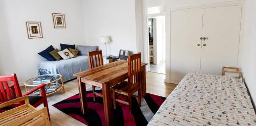a living room with a table and chairs and a couch at Joe's Place Self-Catering in Windhoek