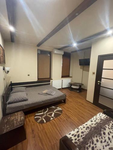 a room with two beds and a couch in it at Міраж in Uzhhorod