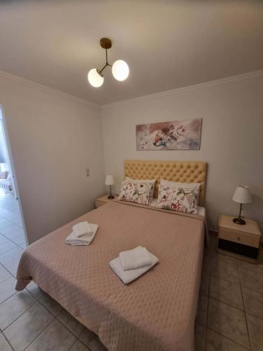 a bedroom with a bed with two towels on it at Menelino, next to local bus and airport station in Argostoli