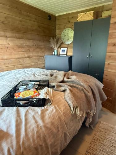 a tray of food on a bed in a room at Karnes Lodge in Oksevik