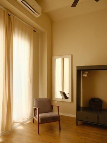 a living room with a chair and a television at Casa Reina Cabanyal in Valencia