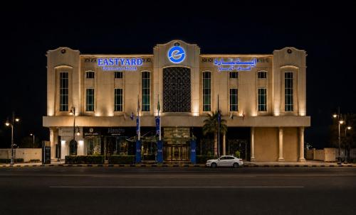 a building with a car parked in front of it at Eastyard Dammam Hotel in Dammam