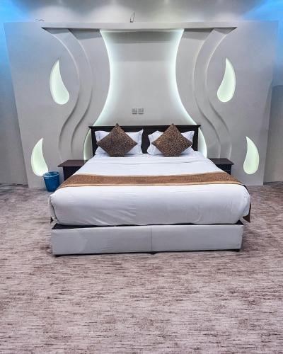 a bedroom with a large bed with white sheets at فلل أرياف - Aryaf in Abha