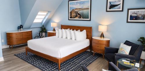 a bedroom with a white bed and a blue wall at Pilgrim House in Provincetown
