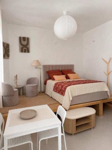 a bedroom with a bed and a table and chairs at Studios Riviera in Bandol