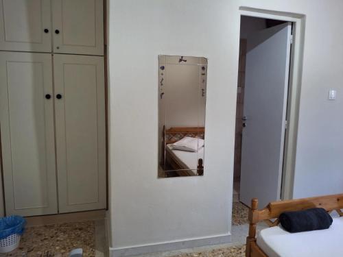 a bedroom with a mirror next to a bed at Salamina Sea View in Kakí Vígla