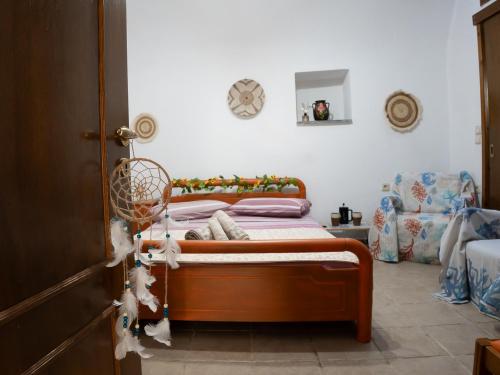 a bedroom with a bed and a chair at Elata Stone Retreat Traditional Village House in Chios