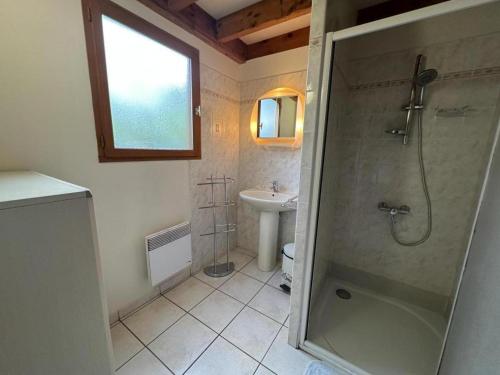 a bathroom with a shower and a sink at Chalet des dunes in Biscarrosse