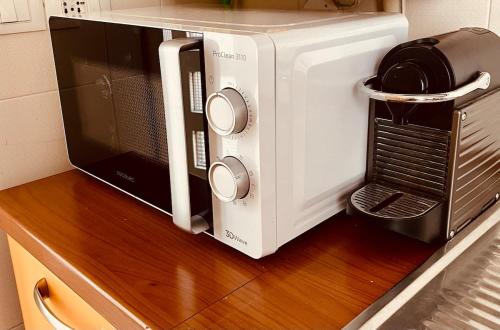 a microwave sitting on top of a wooden counter at A casa di Rita in Udine