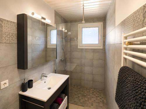 a bathroom with a sink and a mirror at Le Génépi in La Plagne Tarentaise