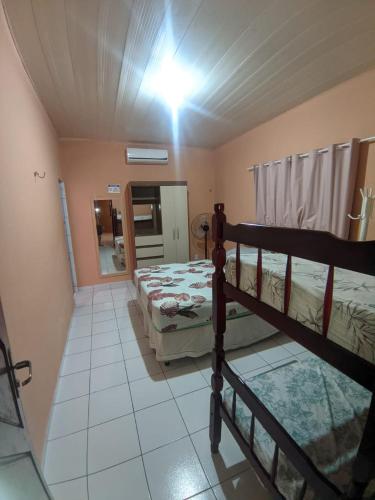 a bedroom with two bunk beds in a room at Casarão Em Pirangi Praia - RN in Parnamirim