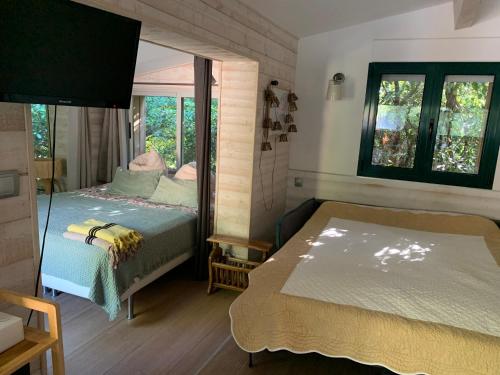 a bedroom with two beds and a window at Cabanon in Sanary-sur-Mer