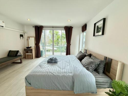a bedroom with a bed and a large window at Sena living Tiwanon Rd in Ban Bang Kradi (1)