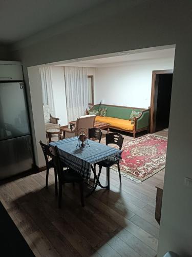 a living room with a table and chairs and a bed at Deniz house apart in Güzelce