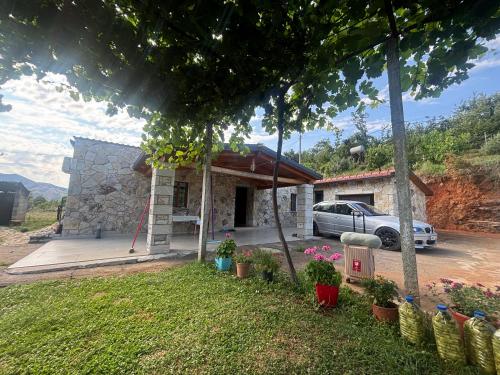 a house with a car parked in front of it at Villa Ndoj Bukmire in Rrëshen