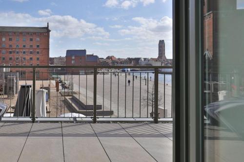 a view of a body of water from a window at Ohlerich Speicher App_ 03 in Wismar