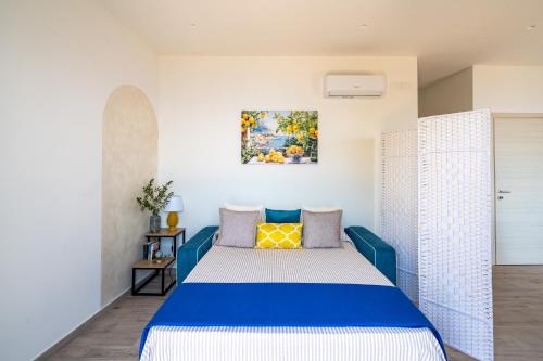 a bedroom with a blue bed in a room at Santa Rosa Relais in Conca dei Marini