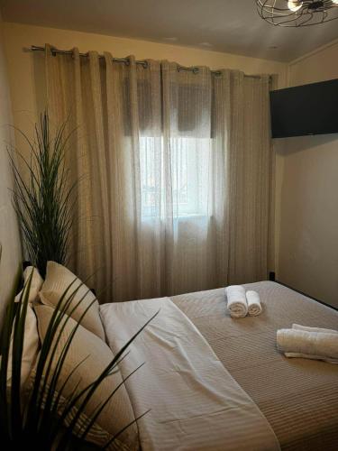 a bedroom with a bed with towels on it at Alegria Suite in Ermoupoli