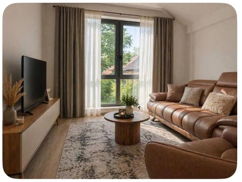 a living room with a couch and a tv at Luxury apartmans in Mavrovo