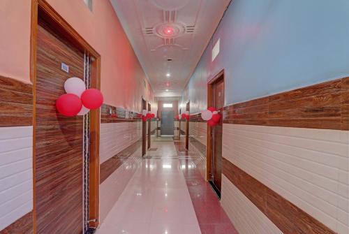 a corridor with red and white balloons in a hallway at Super Hotel O Surya Inn in Varanasi