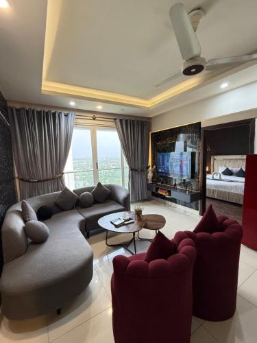 a living room with a couch and a television at ELYSIUM TOWER- One Bedroom Luxury Apartment With Balcony & City View OPP Centaurus Mall Islamabad in Islamabad