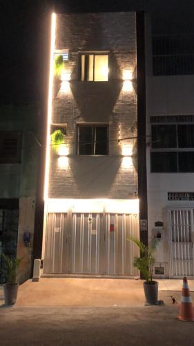 a building with a white garage door with lights on it at Brisa Mar in Fortaleza